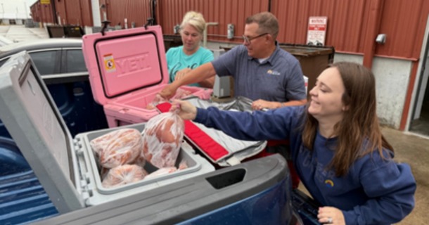 HUW Jeremy Ross and Karly Behrendt load chickens for the Wood River Food Pantry