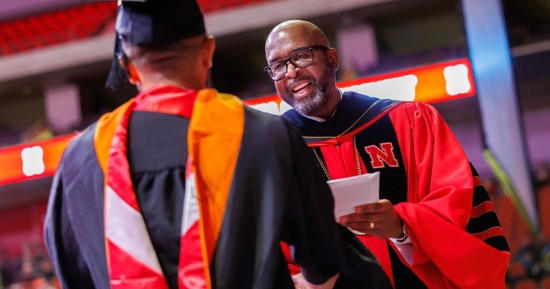 Chancellor Rodney D. Bennett hands a student their master's degree during commencement on Dec. 20, 2024.